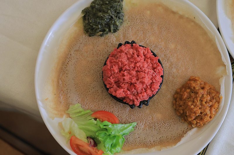Kitfo — spiced minced beef served on injera